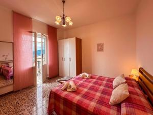 a bedroom with a bed with a red blanket at [5 TERRE]The Terrace on the Gulf - Parking / Wi-fi in Lavagna