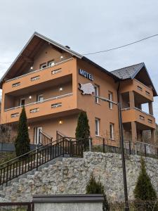 a building with a sign on the side of it at Apartmani Di Casa Dreams in Donji Vakuf