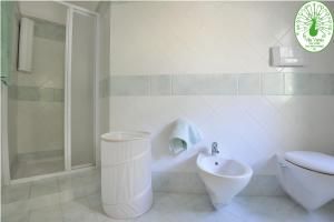 a bathroom with a toilet and a sink and a shower at Apartment Verde in Santa Maria Navarrese +70 photos