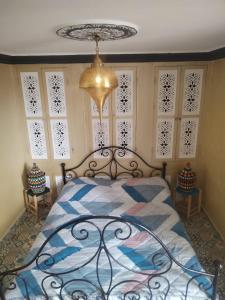 a bedroom with a bed and a chandelier at Hostel artistic airport in Marrakesh