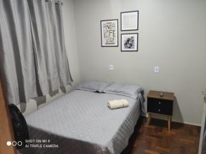 a small bedroom with a bed and a window at IDEAL HOTEL in Cascavel