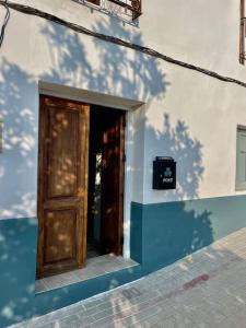 eine Tür an der Seite eines blau-weißen Gebäudes in der Unterkunft Casa Blanca, Acequias, Lecrin valley, Granada in Granada