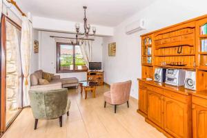 a living room with a couch and a table at Villa Aphrodite Argaka in Argaka +15 photos