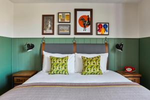 a bedroom with a bed with green walls at Hotel Indigo - Chester by IHG in Chester +153 photos
