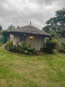 a small house with a thatch roof at Sgele Guesthouse & Events in Vryheid