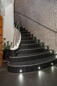 a staircase in a house with black tiles at Nets Inn Apartments - Saint Lazare in Paris