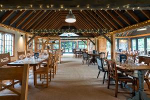 a dining room with wooden tables and chairs at Bourne Valley Inn in Saint Mary Bourne