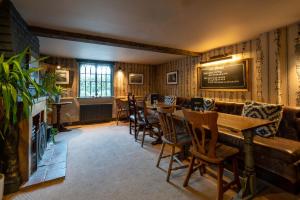 a restaurant with a table and chairs in a room at Bourne Valley Inn in Saint Mary Bourne
