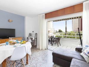 a living room with a table and a couch at Olimpia playa gandia in Playa de Gandia
