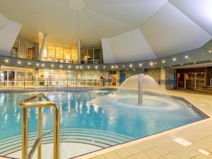 a swimming pool with a fountain in a building at 3 Bed in St. Mellion 87716 in St Mellion