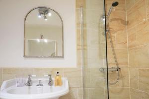 a bathroom with a sink and a shower at Ashore@Jubilee in Filey