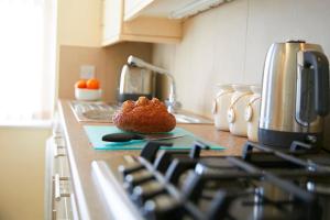 a muffin sitting on top of a stove in a kitchen at Ashore@Jubilee in Filey +12 photos