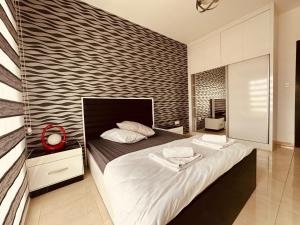 a bedroom with a large bed in a room at 2-Bedroom Apartment Pamfilya 7 by MyGuest Cyprus in Famagusta