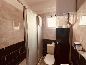 a small bathroom with a toilet and a shower at 2-Bedroom Apartment Pamfilya 7 by MyGuest Cyprus in Famagusta