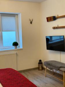 a living room with a flat screen tv on the wall at Maple Lodge Apartments in Braşov