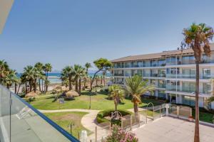 a view of the ocean from the balcony of a building at Playa Esperanza Resort Affiliated by Meliá in Playa de Muro