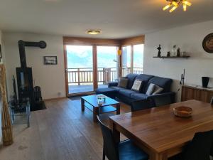 a living room with a couch and a table at Ski Paradise SP 008 - MOUNTAIN & LUXE apartment 4 pers in Veysonnaz