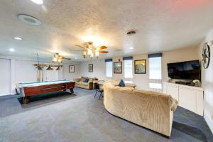 a living room with a couch and a pool table at North Conway Condo with Pool Access 2 Mi to Skiing in North Conway