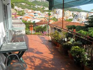balcón con mesa, sillas y plantas en Apartments Dobrinic, en Makarska
