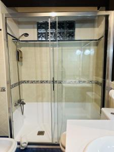 a glass shower in a bathroom with a toilet at Casa Conce Zona de playa y montaña in Llanes