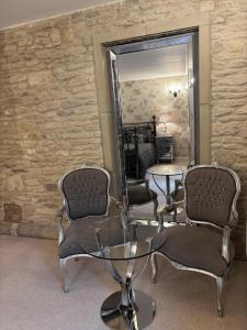 a living room with two chairs and a mirror at Luxury Farm Country Retreat in Chippenham