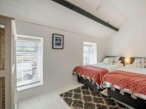 a bedroom with two beds and a window at 3 Bed in Nefyn 55571 in Nefyn