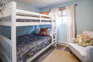 a childs bedroom with bunk beds and a couch at Renovated, Quiet, and 1/2 Mile to BEACH in Cape May