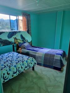 Ein Bett oder Betten in einem Zimmer der Unterkunft Hospedaje San Alberto 202-Ráquira