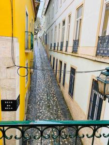 a view of an alley between two buildings at Alfama Charm Apartments - Authentic Lisbon Experience in Lisbon