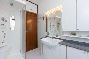 a white bathroom with a sink and a toilet and a shower at Casa Lu by Rental in Rome in Ladispoli +32 photos