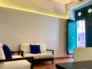 a living room with two chairs and a window at Maratea - Centro Storico - Strada Sospiro in Maratea