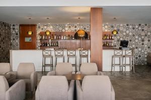 a restaurant with a bar with chairs and a counter at Prinsotel Alba & Spa in Cala d´Or