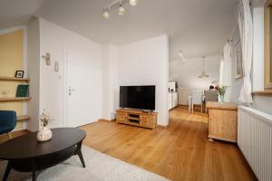 a living room with a flat screen tv on a table at Haus Grundlsee in Grundlsee