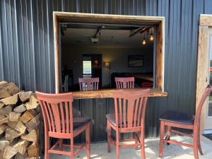 a bar with two chairs and a mirror at Donkeytown at Turner Farms in Heltonville