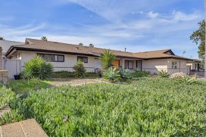 a house with a lot of grass in front of it at Spacious Chula Vista Home with Heated Pool and Hot Tub in Chula Vista