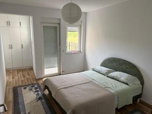 a bedroom with a bed and a window at Luxury private House, near center in Pristina