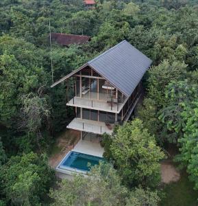 an overhead view of a house with a swimming pool at Wild Grass Nature Resort in Sigiriya