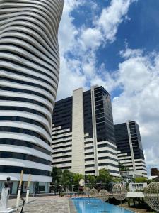 a tall building with a pool in front of it at Puerto Santa Ana, Torres Bellini, 2 dormitorios, Parqueo in Guayaquil