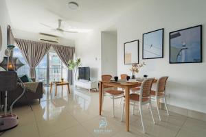 a dining room and living room with a table and chairs at RC Residences @ Sungai Besi Homestay by Birdy Stay in Kuala Lumpur