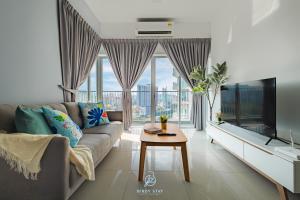 a living room with a couch and a tv at RC Residences @ Sungai Besi Homestay by Birdy Stay in Kuala Lumpur