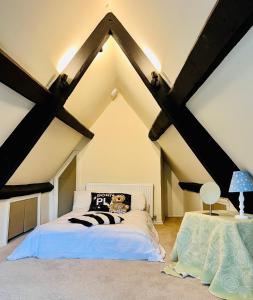 a bedroom with a bed in a attic at Large room in Stunning Cottage Edge of the Cotswolds in Bloxham