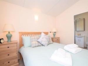 a bedroom with two white towels on a bed at 2 Bed in Sidmouth 76515 in Ottery Saint Mary