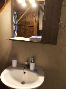 a bathroom with a white sink and a mirror at Σπίτι στην παραδοσιακή πλατεία. in Kámpos