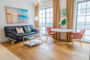 a living room with a couch and a table at 1-Bed Apt with rooftop pool Ocean Dr by the Beach in Miami Beach