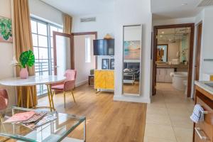 a living room with a table and a dining room at 1-Bed Apt with rooftop pool Ocean Dr by the Beach in Miami Beach