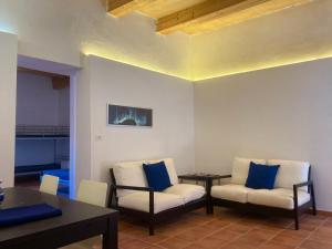 a living room with two chairs and a table at Maratea - Centro Storico - Strada Sospiro in Maratea