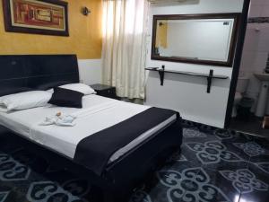 a bedroom with a large bed with a large window at Hotel Mayte in Fonseca