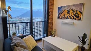 a living room with a couch and a large window at BarrioW Apartment 1 Room, parking, pool and view in Monterrey +19 photos