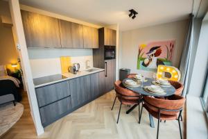a kitchen with a table and chairs in a room at Studio serviced apartments with City view (KS71-R) in Hilversum