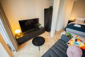 a small living room with a couch and a tv at Studio serviced apartments with City view (KS71-R) in Hilversum